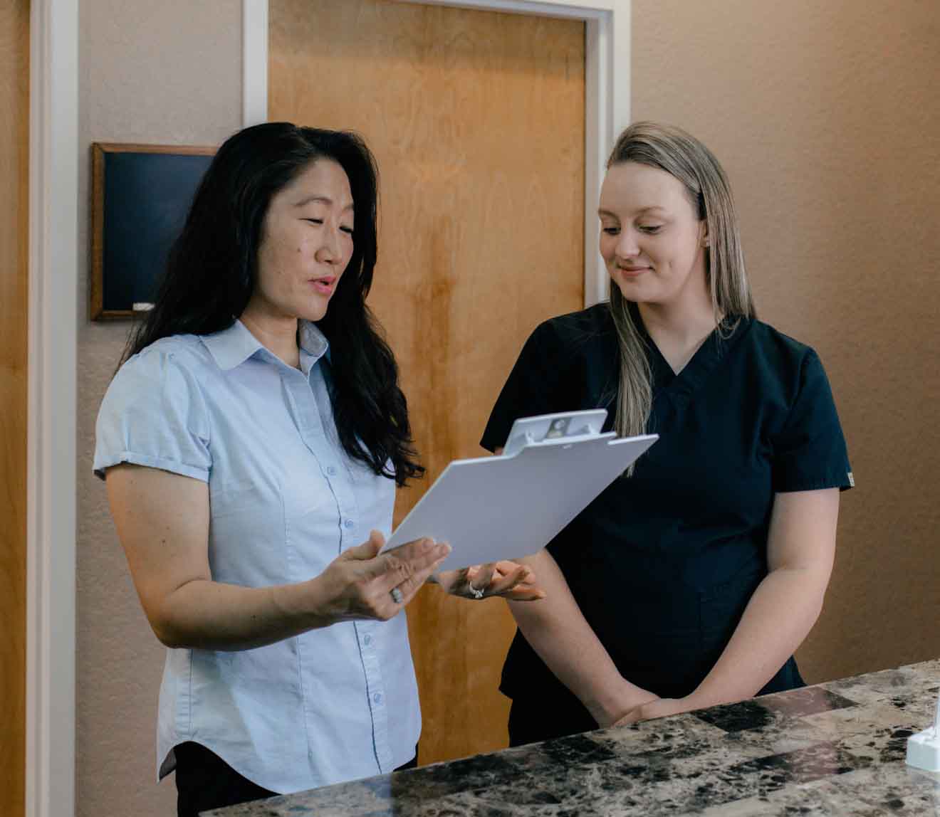 Photo of Nurse Practitioner talking to a Medical Assistant